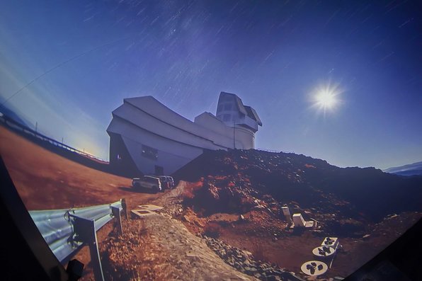 Speaker showing visualization of telescope dome on mountaintop