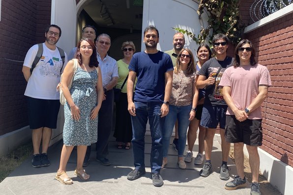 Researchers standing outside entrance to building